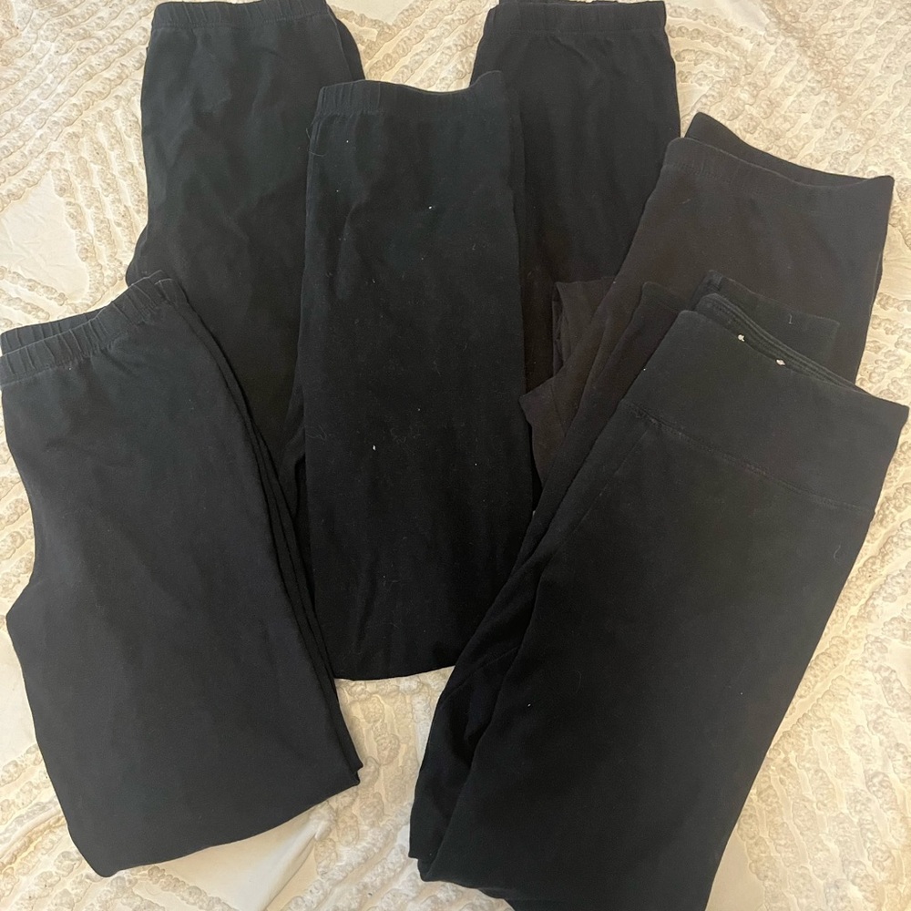 Six pairs of black leggings.